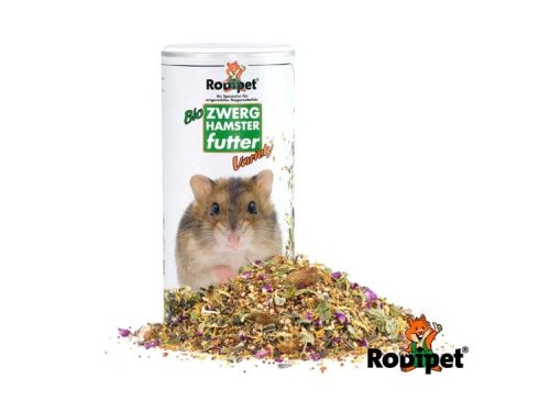 Økologisk foder til dværghamstere fra Rodipet, præsenteret i en tærteformet beholder med en blanding af urter, frø og snacks.